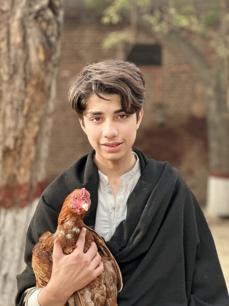 The boy holding his rooster from The Rooster and the Boy film